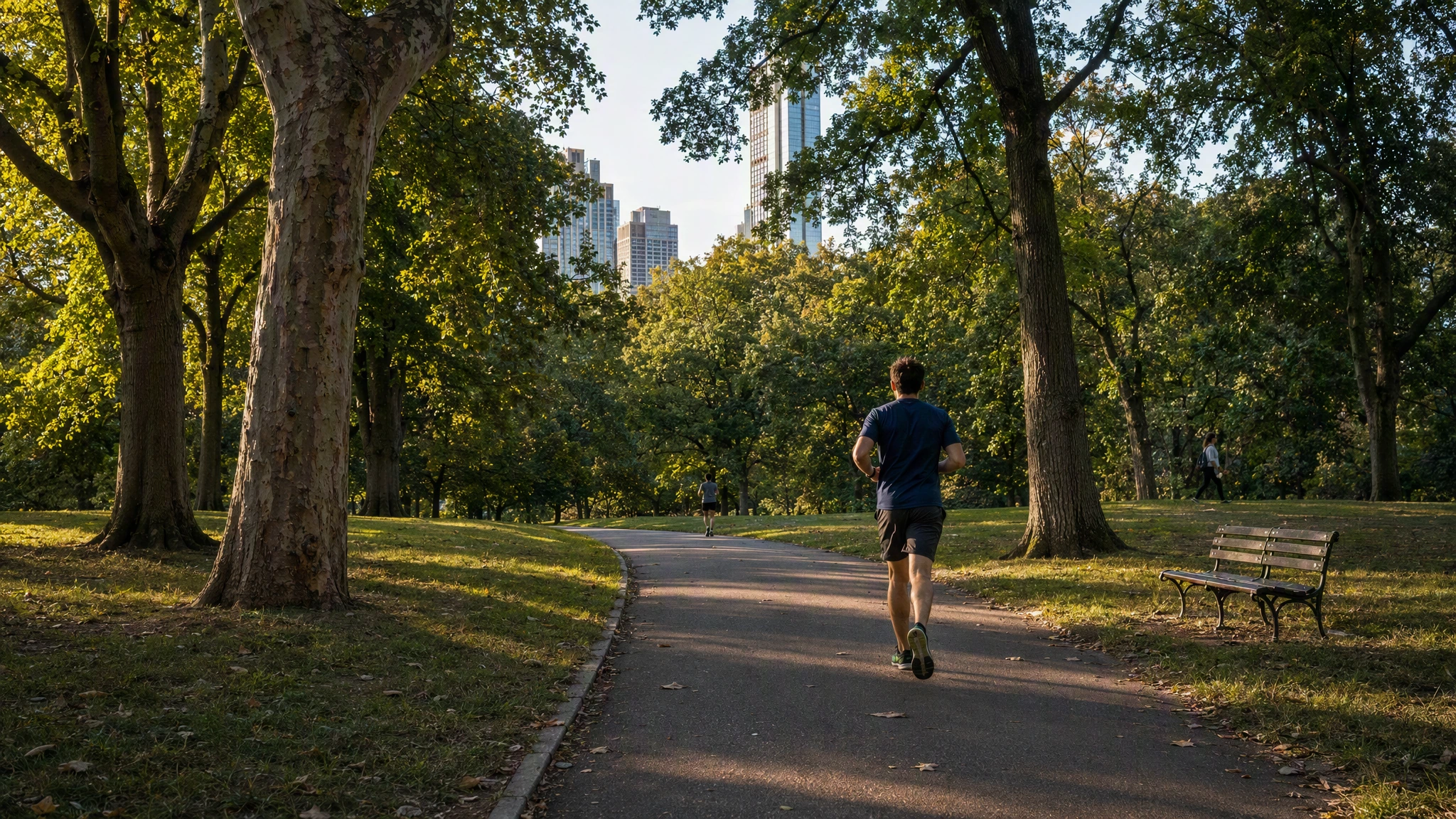 A runner moving along a green public park path.